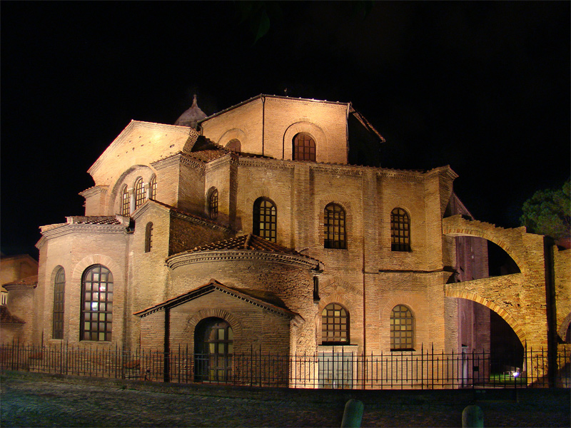 Photo of a basilica with many paned windows; taken in the dark.