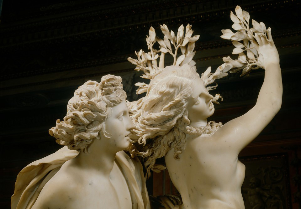 Marble sculpture of Apollo and Daphne by Gian Lorenzo Bernini. Shown is Apollo with his hand on Daphne's hip as she resists his touch almost as if she tries to get away from Apollo.