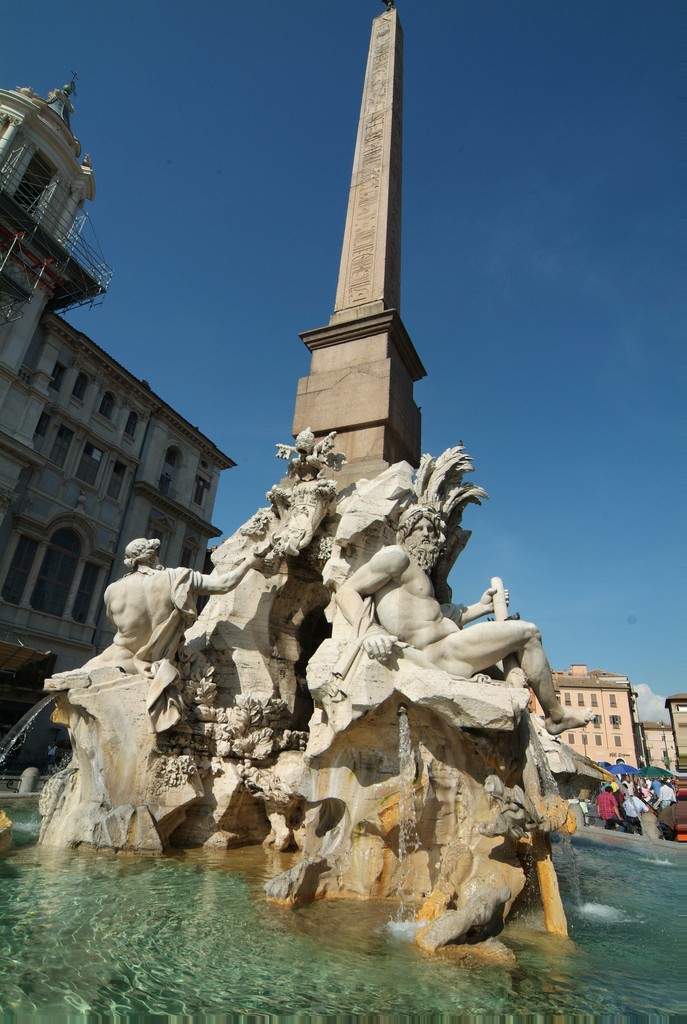 Image of the Fountain of the Four Rivers by Gian Lorenzo Bernini, marble fountain. The fountain supports an ancient Egyptian obelisk over a hollowed-out rock, surmounted by four marble figures symbolizing four major rivers of the world.
