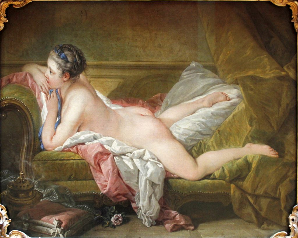 Image of the Blond Odalisque by Francois Boucher. Shown is a young woman laying nude, resting her arms and chin on the arm of a couch. She is thought have been a mistress of King Louis XV. Oil on canvas painting.
