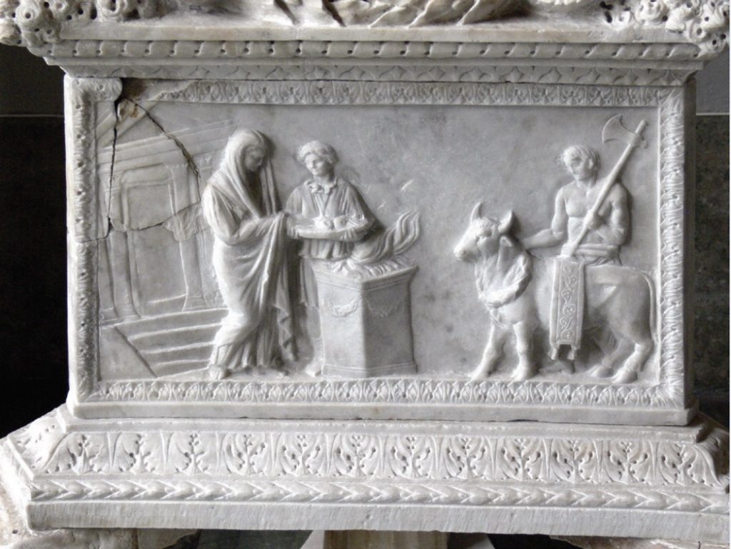 Photo of relief sculptures on a stone altar.