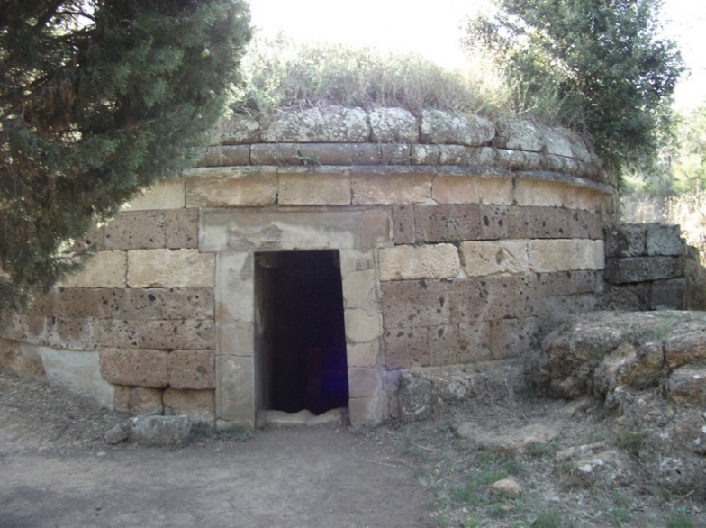 Photo of a mound tomb made of stone blocks of soft rock.