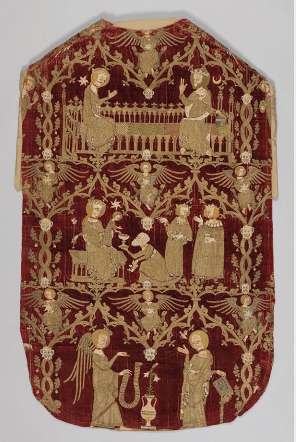 Photo of vestments in red with gold embroidery depicting religious scenes.