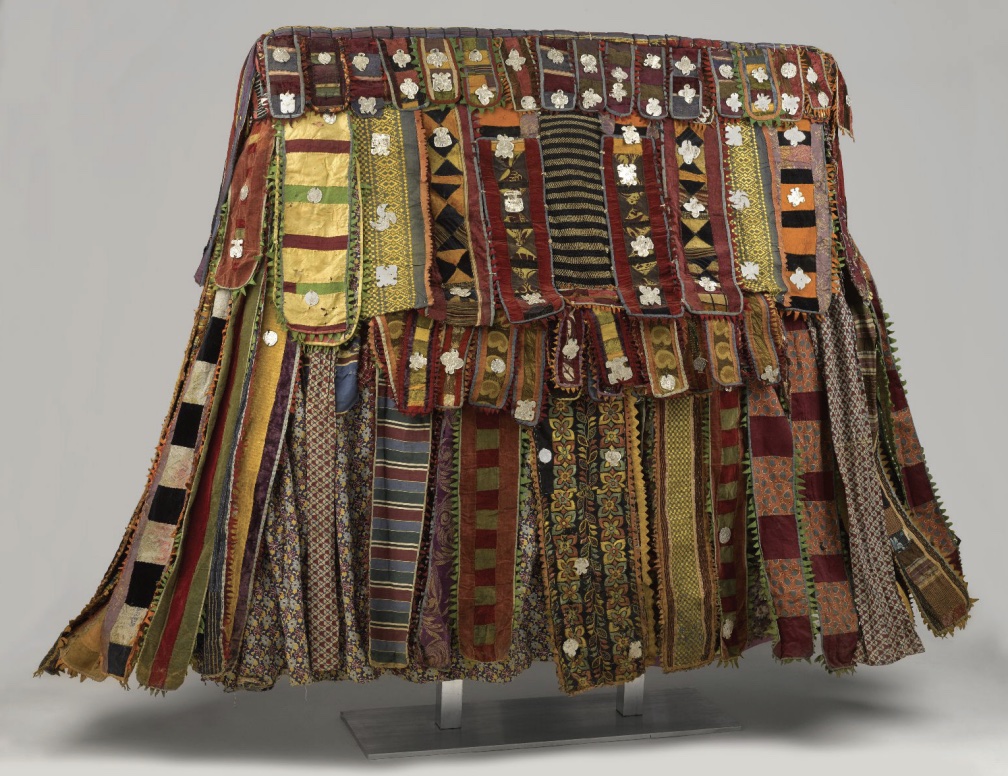 Skirt-like costume made of strips and layers of cloth in various colors.