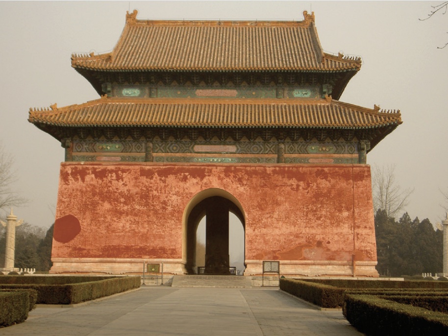 Photo of large and colorful gateway with pagoda-like structure and roof.