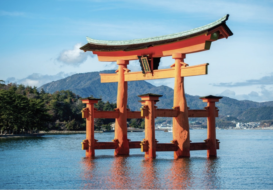 Photo of a gate-like structure constructed of bright orange columns set at sea, photo taken at high tide.