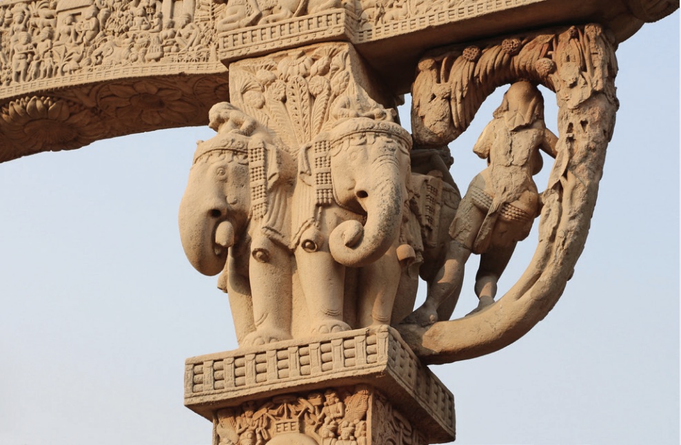 Photo of female nature figure with 4 decorated elephants next to her.
