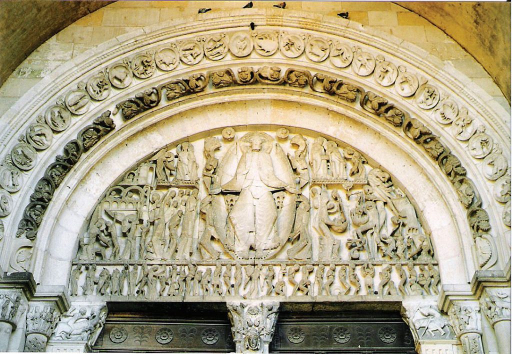 Photo of a tympanum showing elongated figures during the Last Judgement.